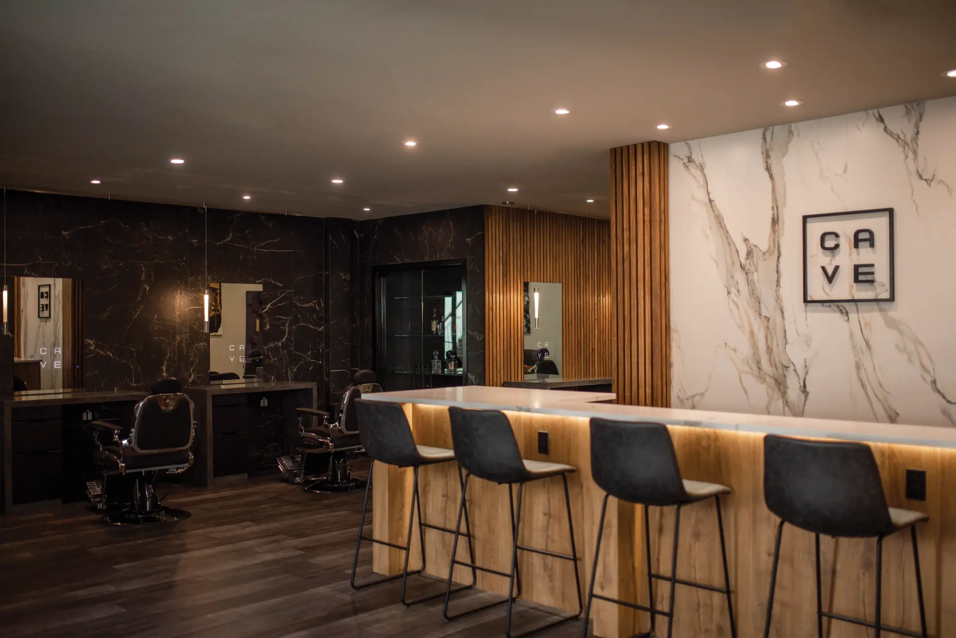 CAVE interior with marble, wood, and barber stations